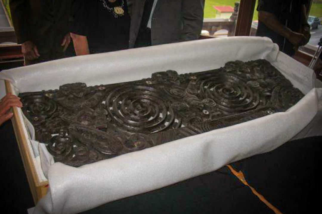 Carved Māori pare (lintel) in packing crate
