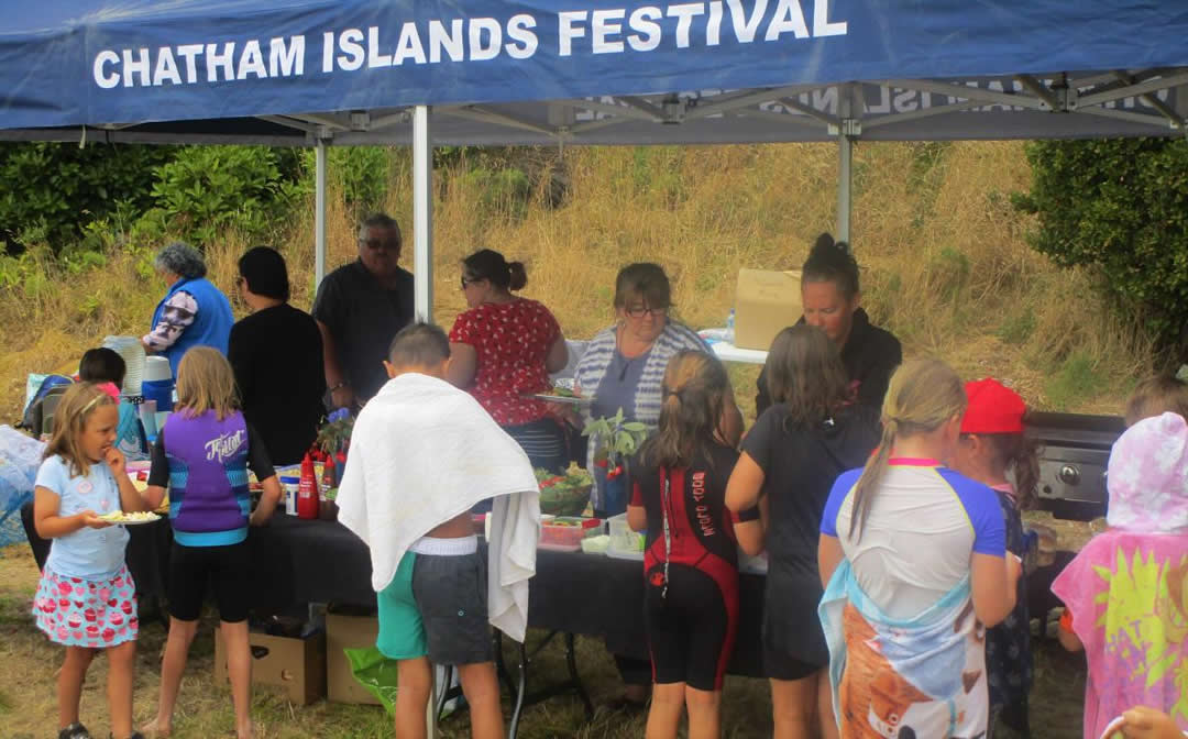 Children getting kai from open tent at the Chatham Islands Festival