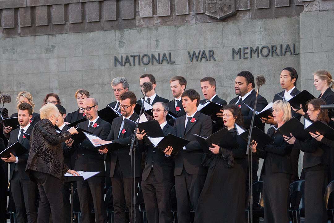 Choir in all black singing outside the National War Memorial.