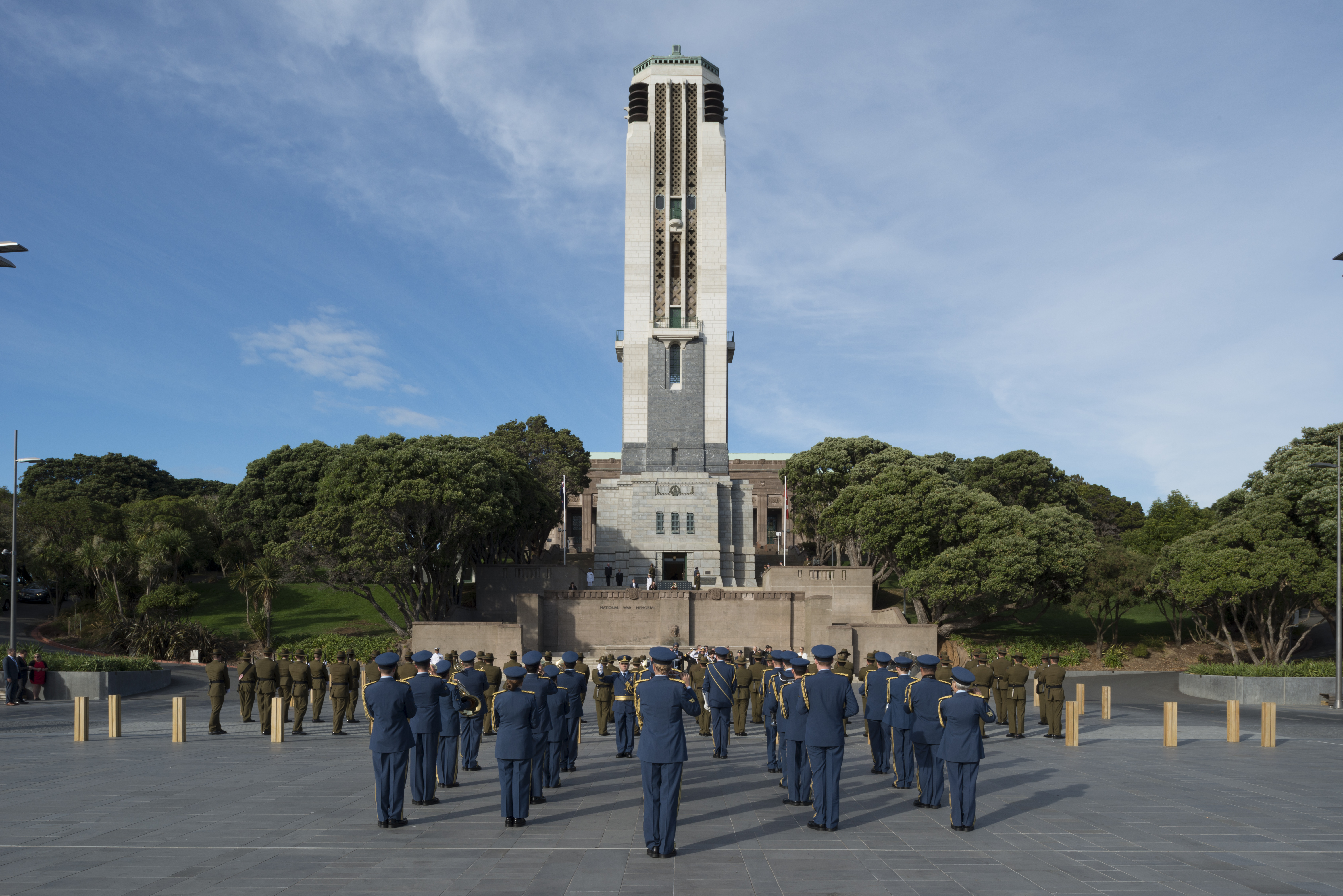 The Carillon Tower with a  military band and soldiers standing in front of it.