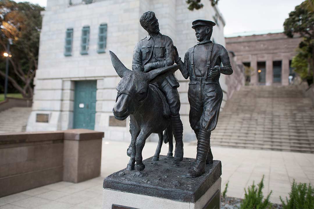 Small statue of two men, one is riding a donkey.