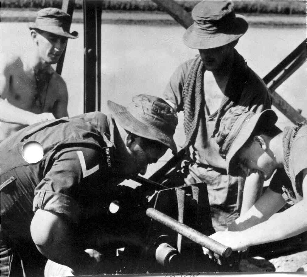 Four soldiers working on a steel bridge