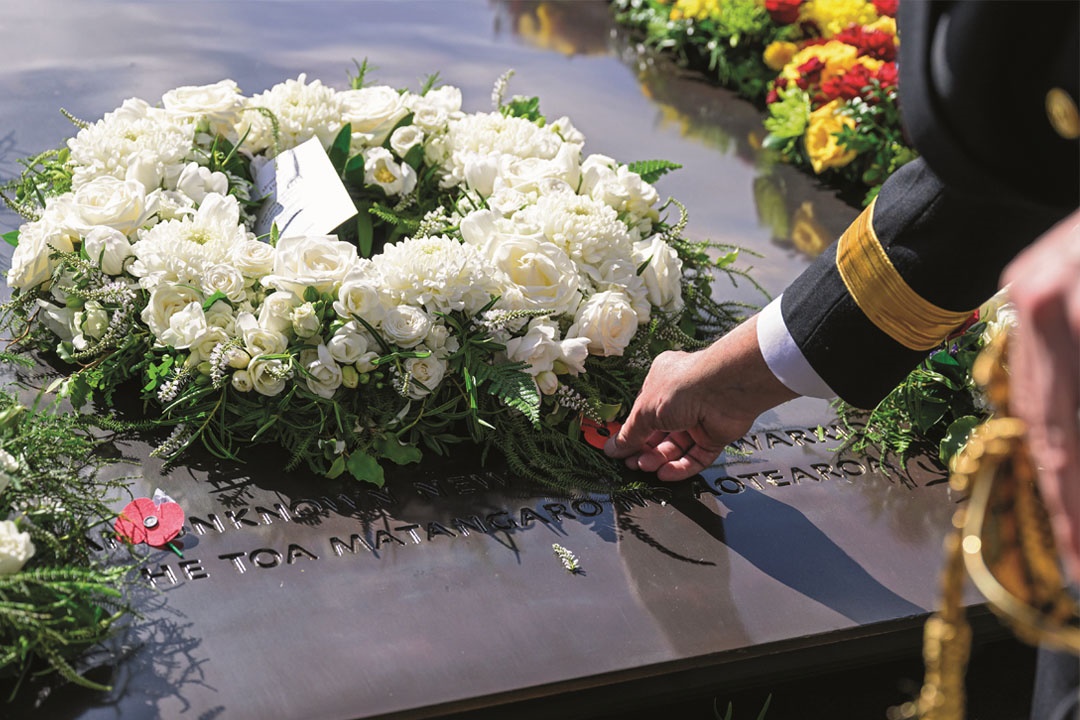Military officer laying a poppy on the Tomb of the Unknown Warrior