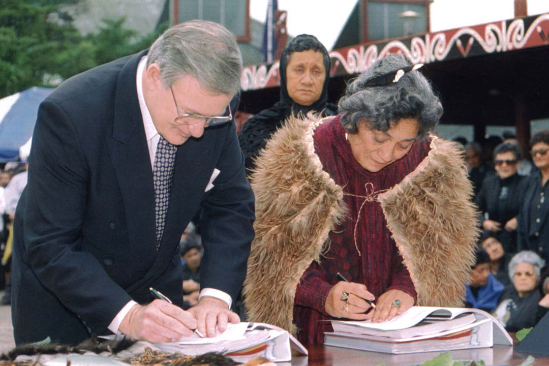 Jim Bolger and Dame Te Atairangikaahu signing documents