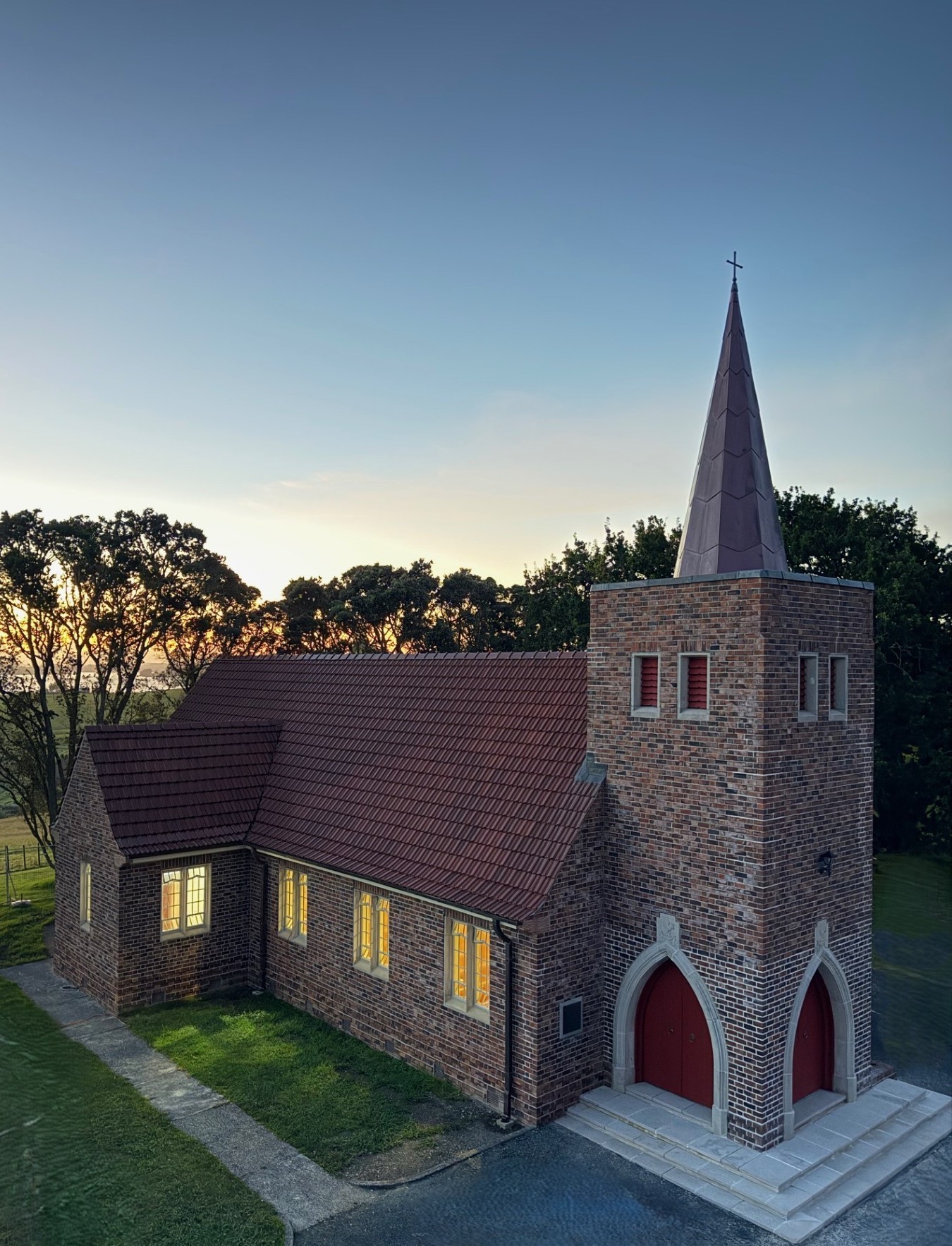 Profile view of church and spire at dusk