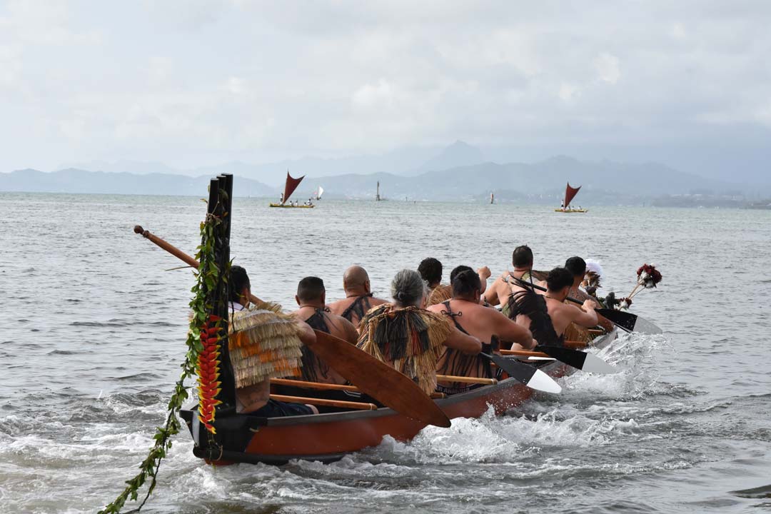 Waka full of paddlers heading out to sea