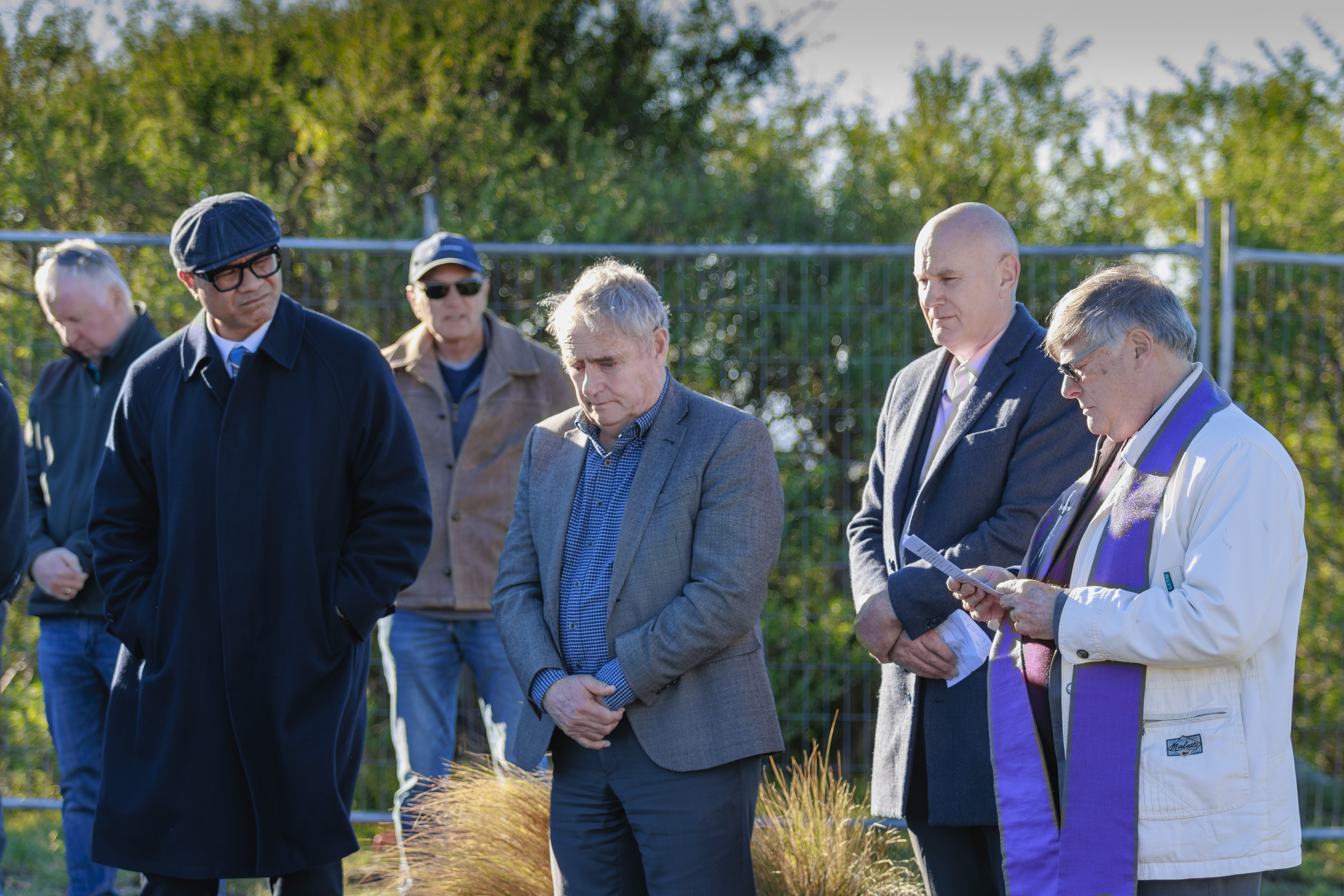 Priest and others standing at blessing ceremony