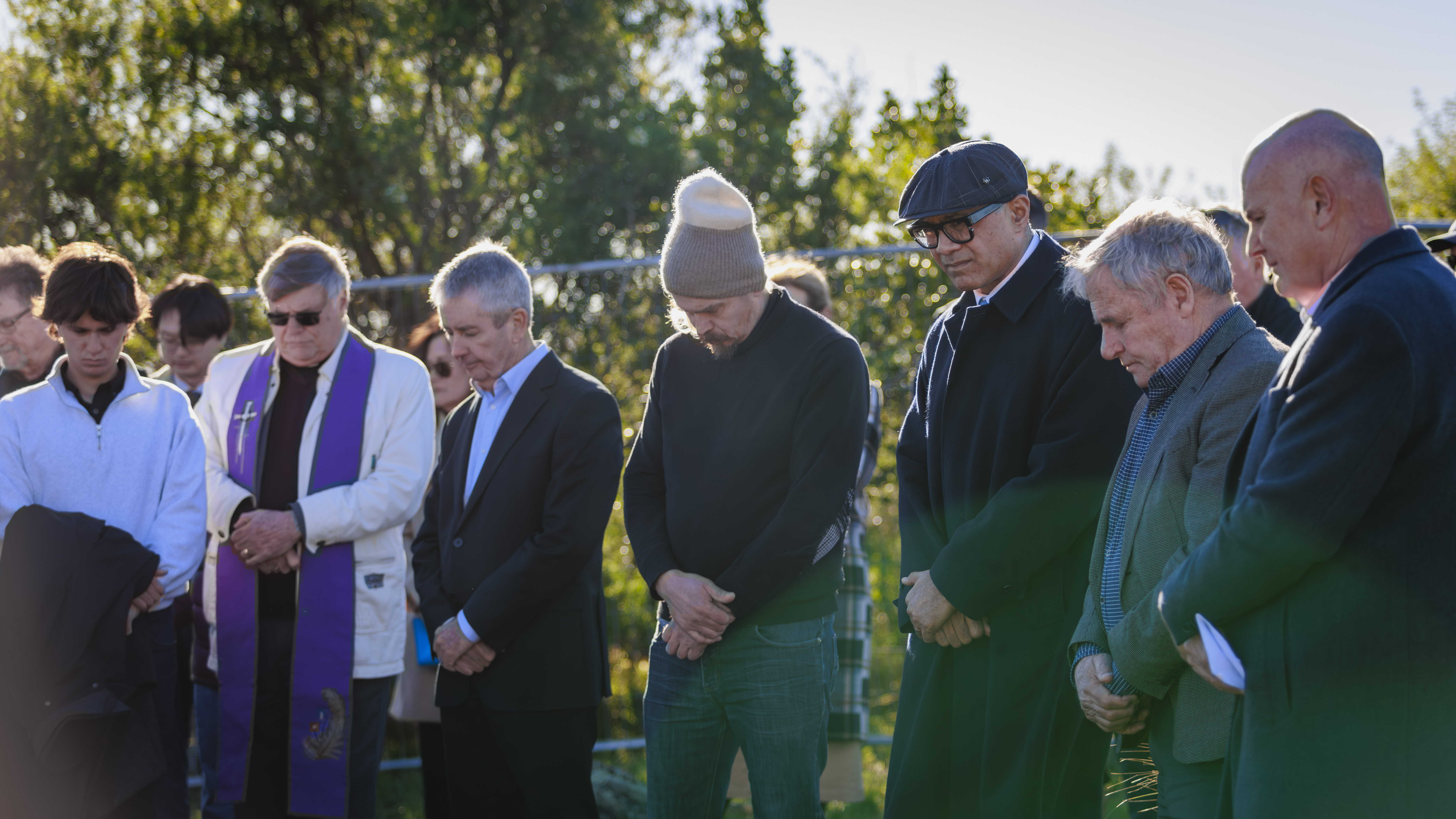 Group with hands crossed at blessing ceremony