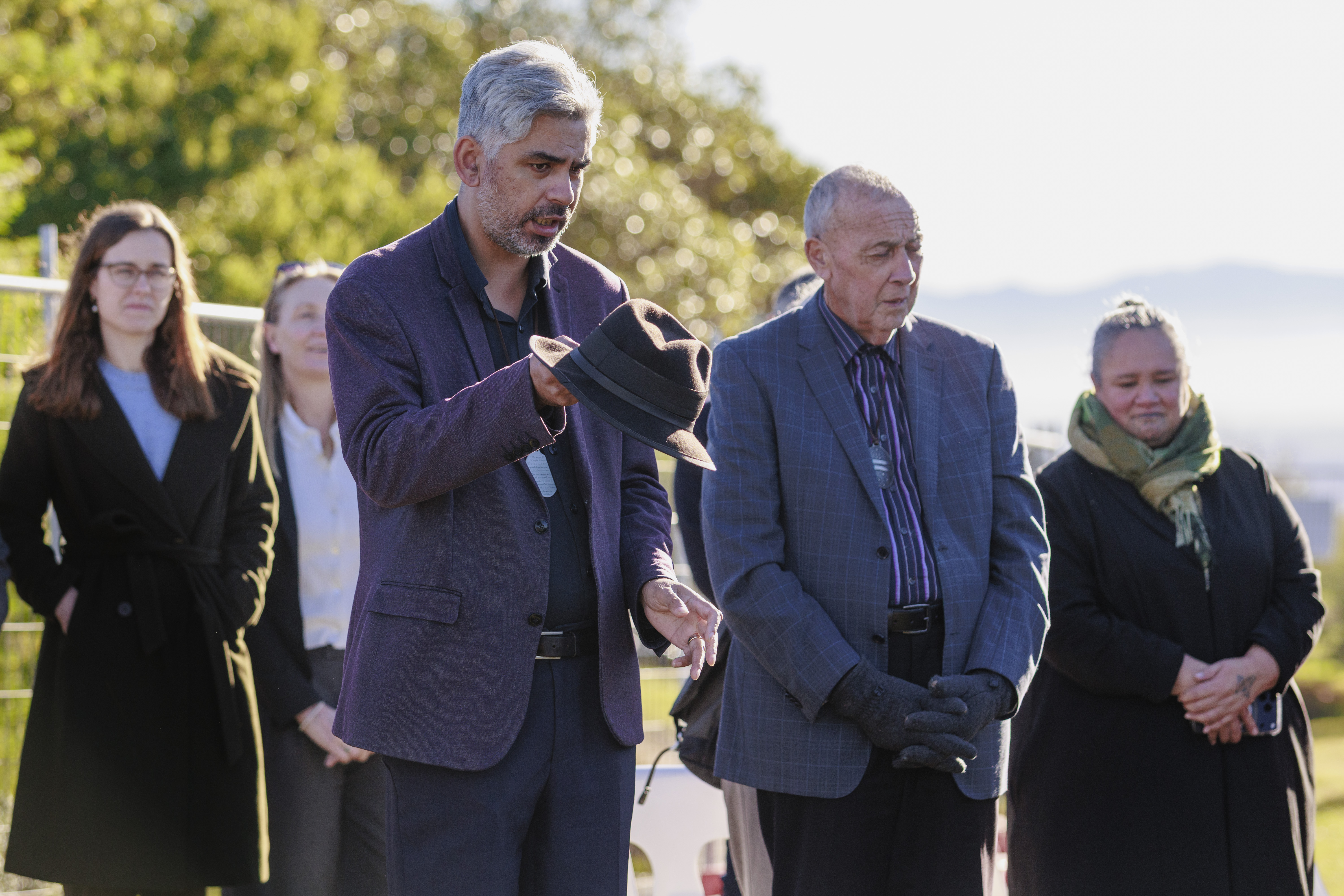 Man speaking while others look on at blessing ceremony