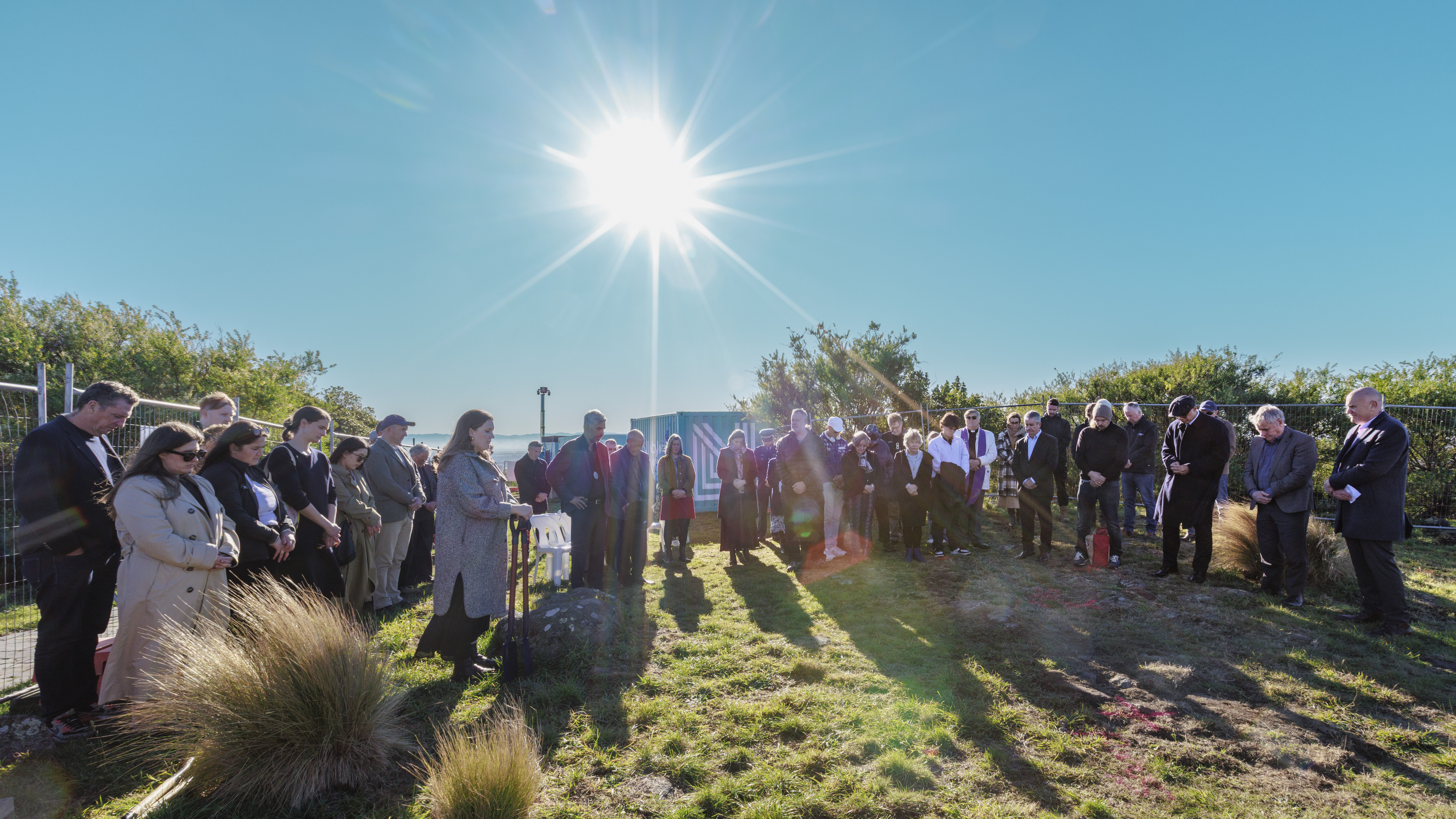 Crowd blessing site with sun rising