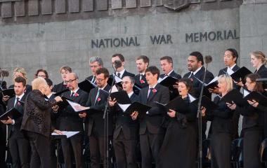Choir in all black singing outside the National War Memorial.
