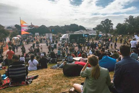 Group enjoying festivities on a grassy bank