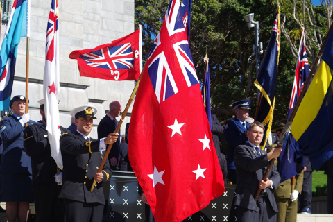Person in uniform holding a red flag