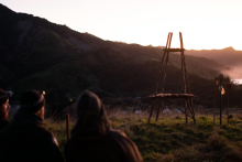 A couple watch the sunrise over the horizon 