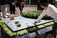 Person placing a poppy on the Tomb of the Unknown Warrior